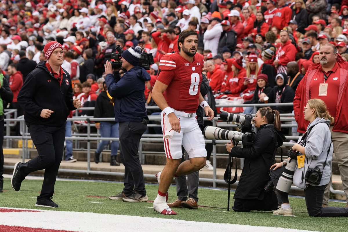 Oct 14, 2023; Madison, Wisconsin, USA; Wisconsin Badgers quarterback Tanner Mordecai (8) runs to the locker room during the second quarter against the Iowa Hawkeyes at Camp Randall Stadium. Mandatory Credit: Jeff Hanisch-USA TODAY Sports